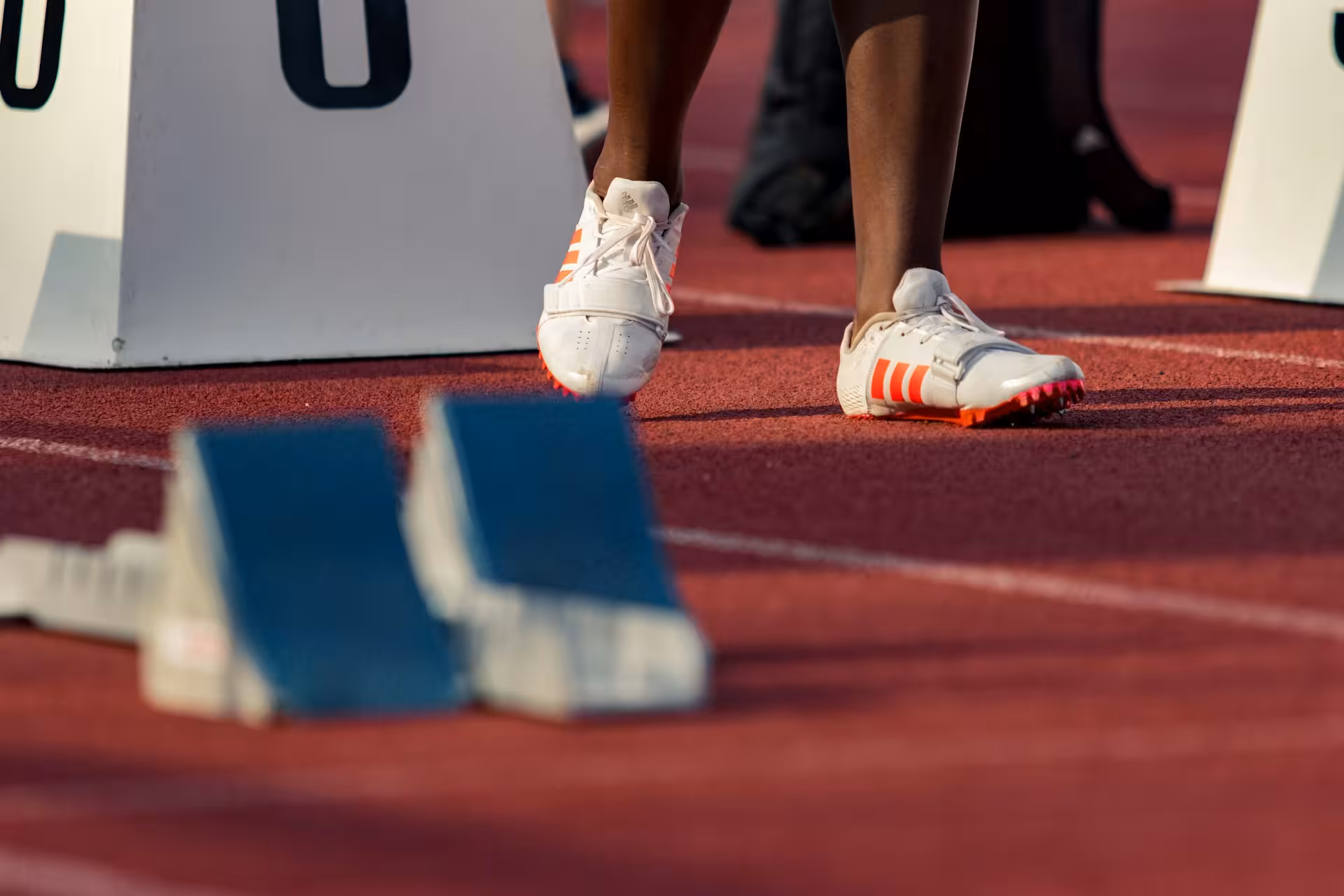 Doctor examining an athlete's knee in a clinic